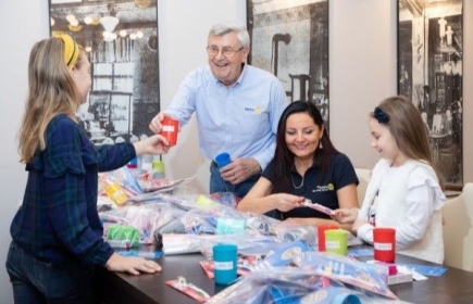 Exdirector de  RI, Piotr Wygnańczuk, ayuda a socios de RC Elblag Centrum a empacar kits de cepillado de dientes